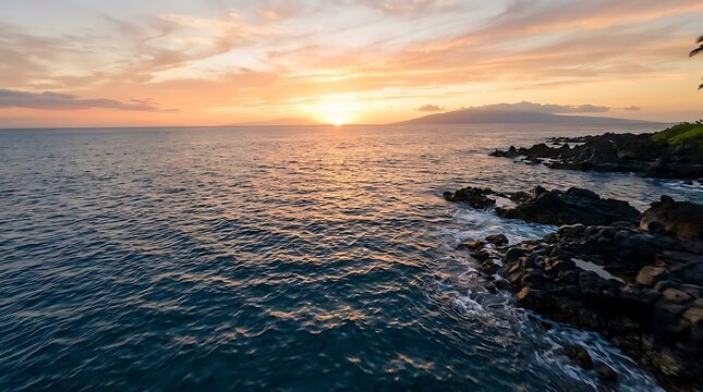 Sunset over ocean with rocky coastline