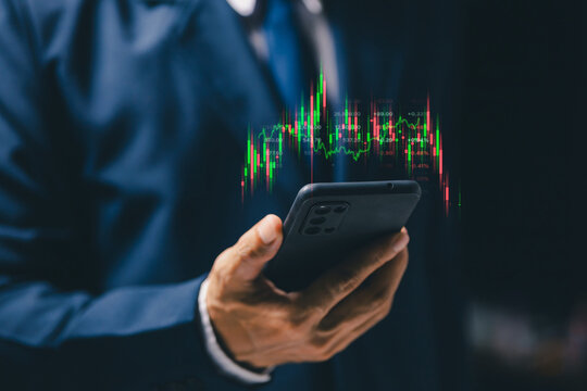 Mobile stock trading concept with professional using smartphone and virtual candlestick chart, representing financial markets, investment analysis, fintech technology and online trading.