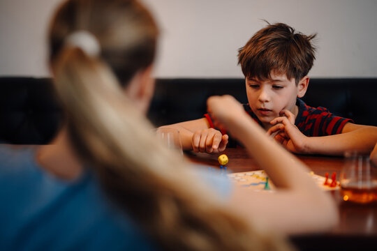 Children playing board game concentrating on strategy