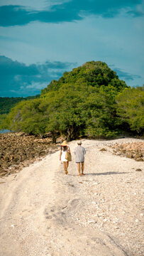 The couple traveler are working in the mid-ground of the sea summer on isolation island, tropical island traveling together