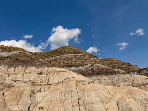 Badlands hoodoo rock formations under blue sky in Drumheller Alberta