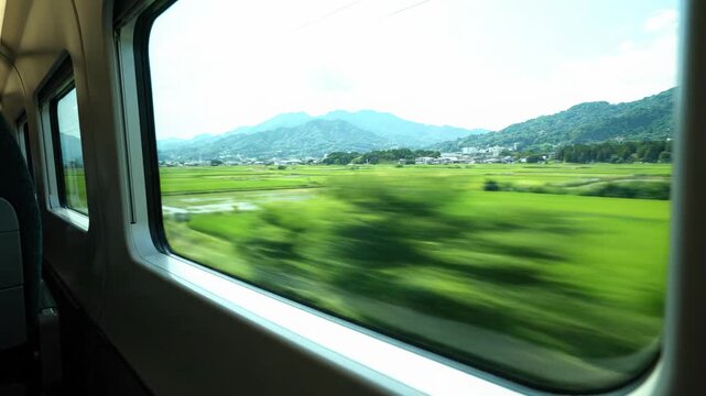 Train Window View Serene Countryside Landscape, Vibrant Green Fields, Distant Hills, Natures Journey, Peaceful Travel, Scenic Escape, Blurring Scenery, Rolling Hills, Evoking Tranquility