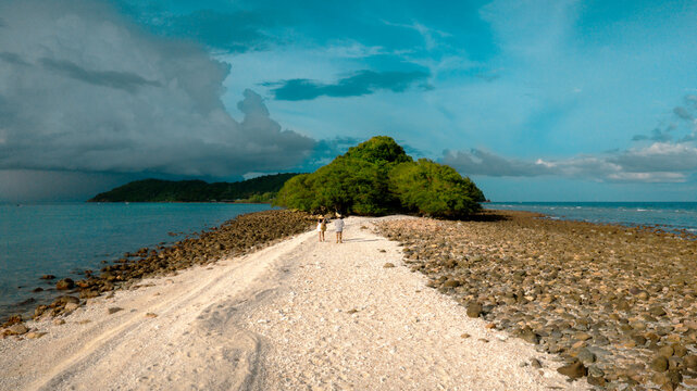 The couple traveler are working in the mid-ground of the sea summer on isolation island, tropical island traveling together