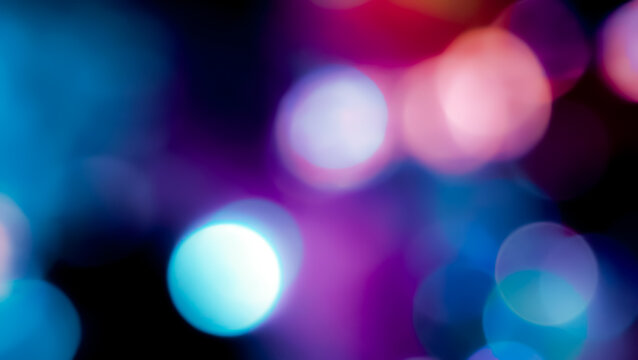 Cinematic abstract bokeh background with soft blurred glowing circles in shades of blue and purple for creative backdrop design