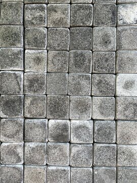 Andesite natural stone attached to the wall in a small grid pattern.