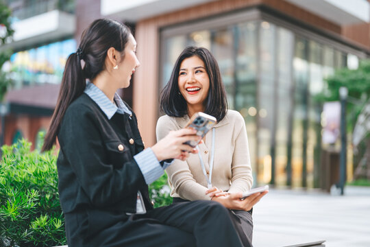 Authentic two business women talking positive confidence conversation happiness social gathering at outdoor park