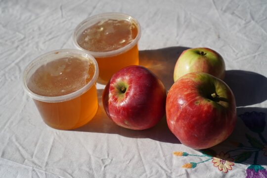 Fresh red apples and natural organic honey for Slavic holiday Spas festival. Eco-friendly farm food, traditional Apple Spas and Honey Spas celebration. Organic harvest, healthy sweet food, and traditi