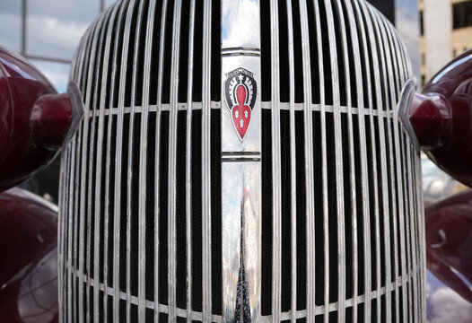 Ufa, republic of Bashkortostan, Russia- 04.26.2026. Close-up of a vintage Oldsmobile chrome radiator grille with classic emblem. Shiny retro automobile front detailing vertical metal bars. Antique car