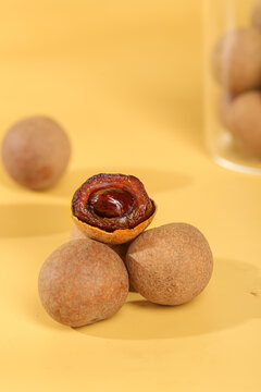 Dried Longan Fruits Asian Delicacy Traditional Chinese Medicine Healthy Snack Yellow Background