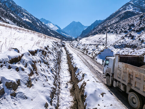 Dump Truck on Snowy Mountain Road in Kyrgyzstan