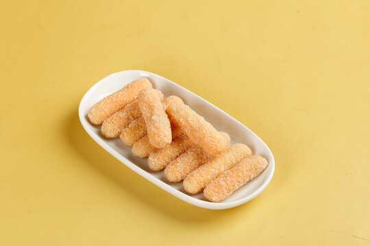 Traditional Chinese Glutinous Rice Sticks Dessert on Yellow Background Beijing Sweet Snack