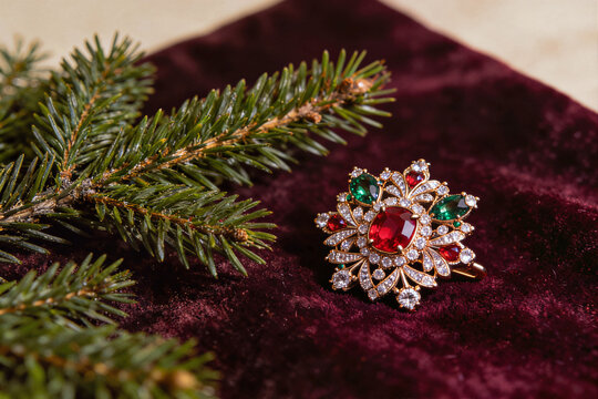 Red and green crystal brooch on velvet with fir branch