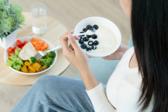 healthy food. Beautiful female girl enjoy eat yogurt, granola, fresh fruits on breakfast health in house. Happy young woman smile on morning good emotion. dieting, detox, diet, clean eat, vegetarian