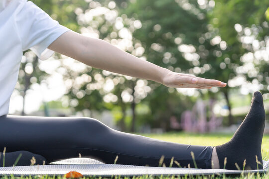 health care female exert on the park. Asian woman doing exercises in morning. balance, recreation, relaxation, calm, good health, happy, relax, healthy lifestyle, reduce stress, peaceful, Attitude.
