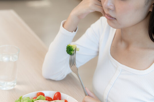 slim body asian women very bored diet food, dieting female choose low calories food for diet. Good healthy food. weight lose, balance, control, reduce fat, routines, exercise, body shape