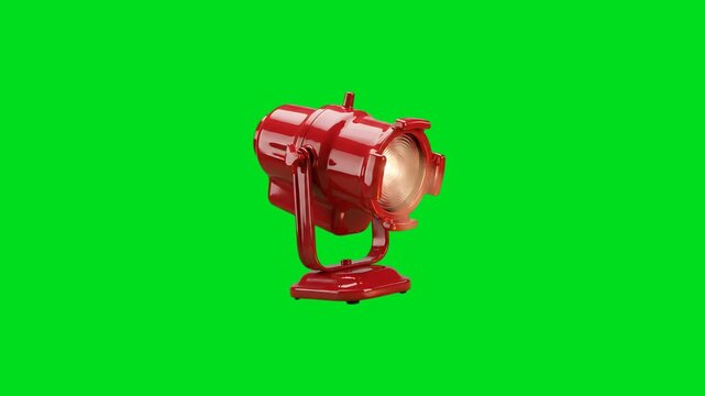 A vibrant red vintage studio spotlight isolated against a bright green screen