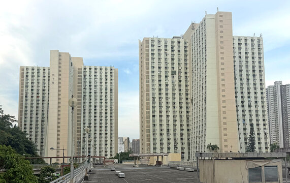 Hong Kong residential apartment buildings under a cloudy sky in an urban setting