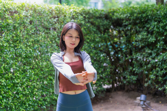 Asian sport woman stretching in park