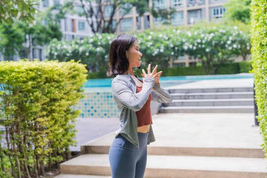 Asian sport woman stretching in park