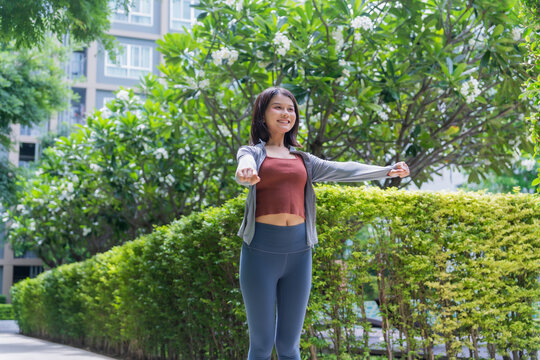 Asian sport woman stretching in park