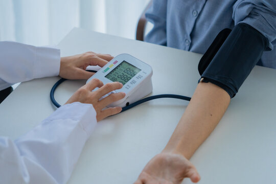 Doctor cheking patient's blood pressure