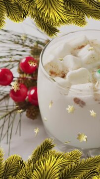 Animation of stars falling over christmas drink and decorations