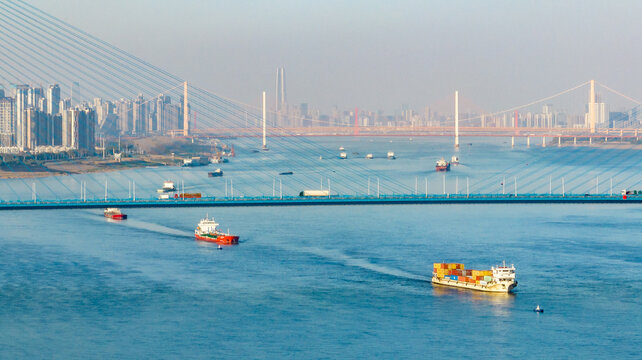 Modern Freighter Ships on Yangtze River with Urban Skyline and Bridges