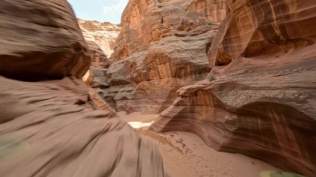 Slot canyon red sandstone desert narrow passage landscape nature exploration travels through twisting orange rock walls beneath sunlight and highlights erosion patterns for travel marketing