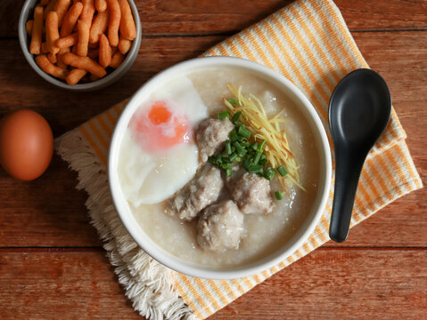 Congee or rice porridge top with minced pork, ginger and green onion. Popular breakfast bowl in China, Thailand, and Asia.
