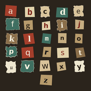 Alphabet of ransom note letters cut from colored paper against a dark background with alphabet