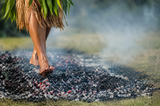 Fiji Independence Day cultural background, man walking on hot coals, tribal ritual, traditional grass costume.