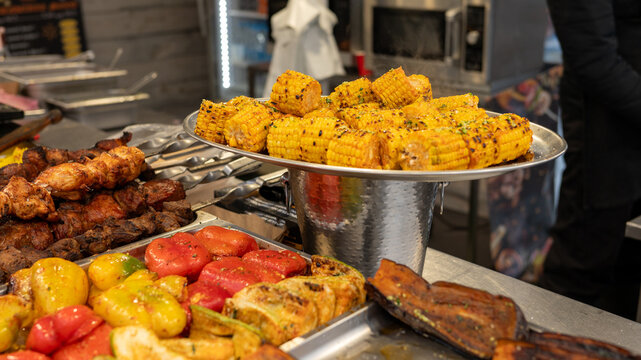 Delicious grilled street food with corn, vegetables, and meat displayed