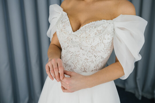 Female bride in lace off-shoulder wedding dress with elegant sleeves National Wedding Month