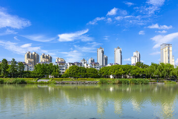 Fototapeta premium Modern lakeside residential skyline under blue summer sky