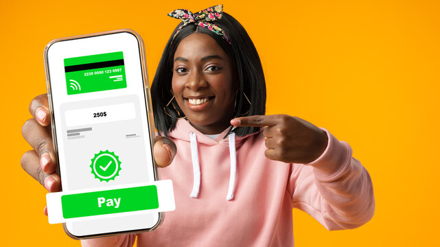 Happy person pointing at phone screen showing online payment confirmation