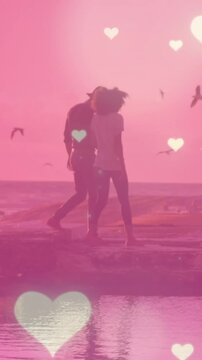 Animation of hearts over couple at beach