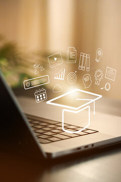 E learning with laptop showing graduation hat and education icons in a workspace