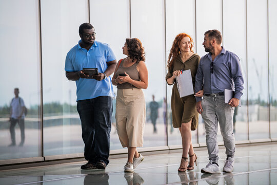Diverse group of professionals walking and talking