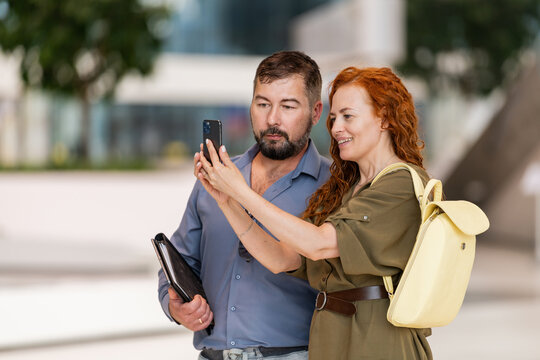Happy couple taking a selfie together outdoors