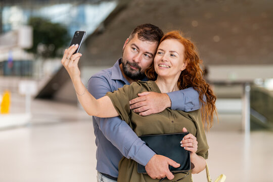 Smiling middle aged couple taking a selfie