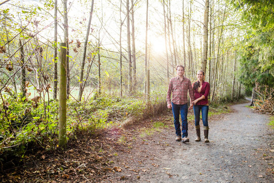 Happy couple taking a romantic walk in the woods