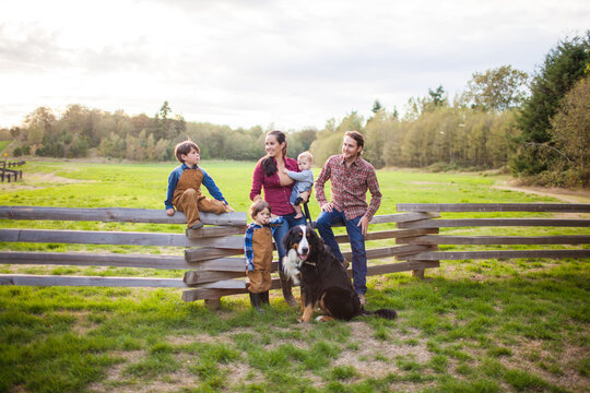 Happy family of five with a dog in the country
