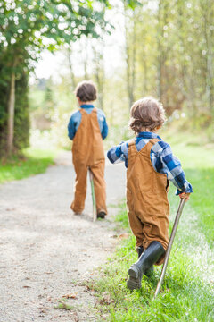 Two young boys walking on a country path