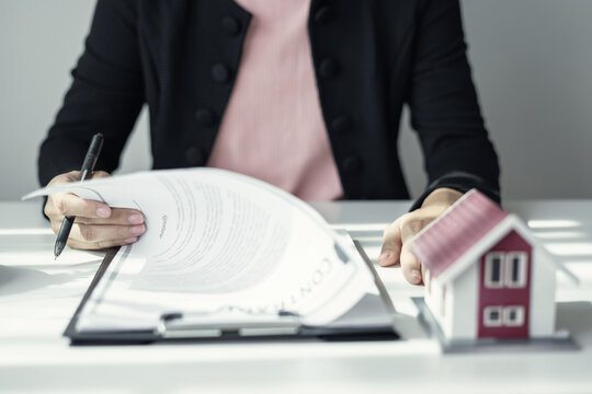 cagents working in real estate investment and home insurance signing contracts in accordance with the home buying insurance agreements approving purchases for clients