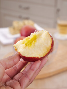 Fresh Red Apple Slice in Hand - Healthy Snack with Natural Bite Mark