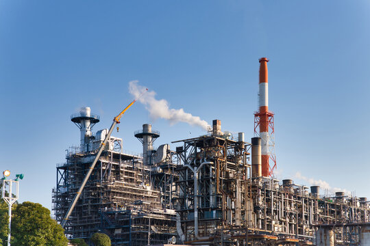 Factory scene. Industry, manufacturing, industrial sector, oil refinery, energy, petrochemicals, buildings, construction, electric power, power plant, technology, blue sky.