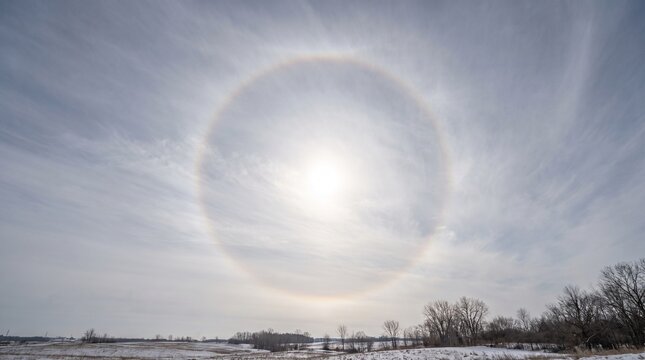 Sun halo over snowy winter landscape