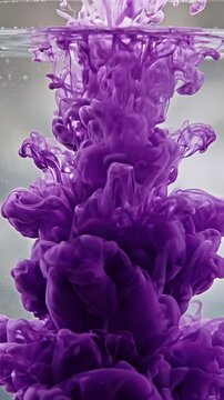 Purple Ink Droplets Dissolving in Water - Vivid purple ink droplets are seen dissolving and swirling within clear water.