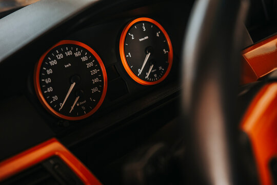 Close-up of car dashboard showing speedometer and rpm gauge