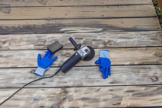 Outdoor tools on wooden surface, ready for use in a repair or maintenance task